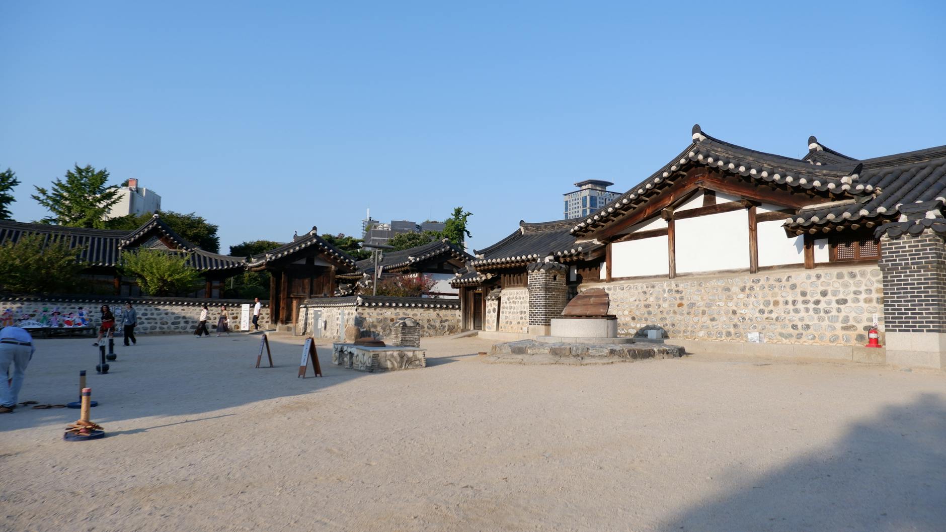 Explore traditional Hanok village architecture under a bright blue sky in Seoul, South Korea.
