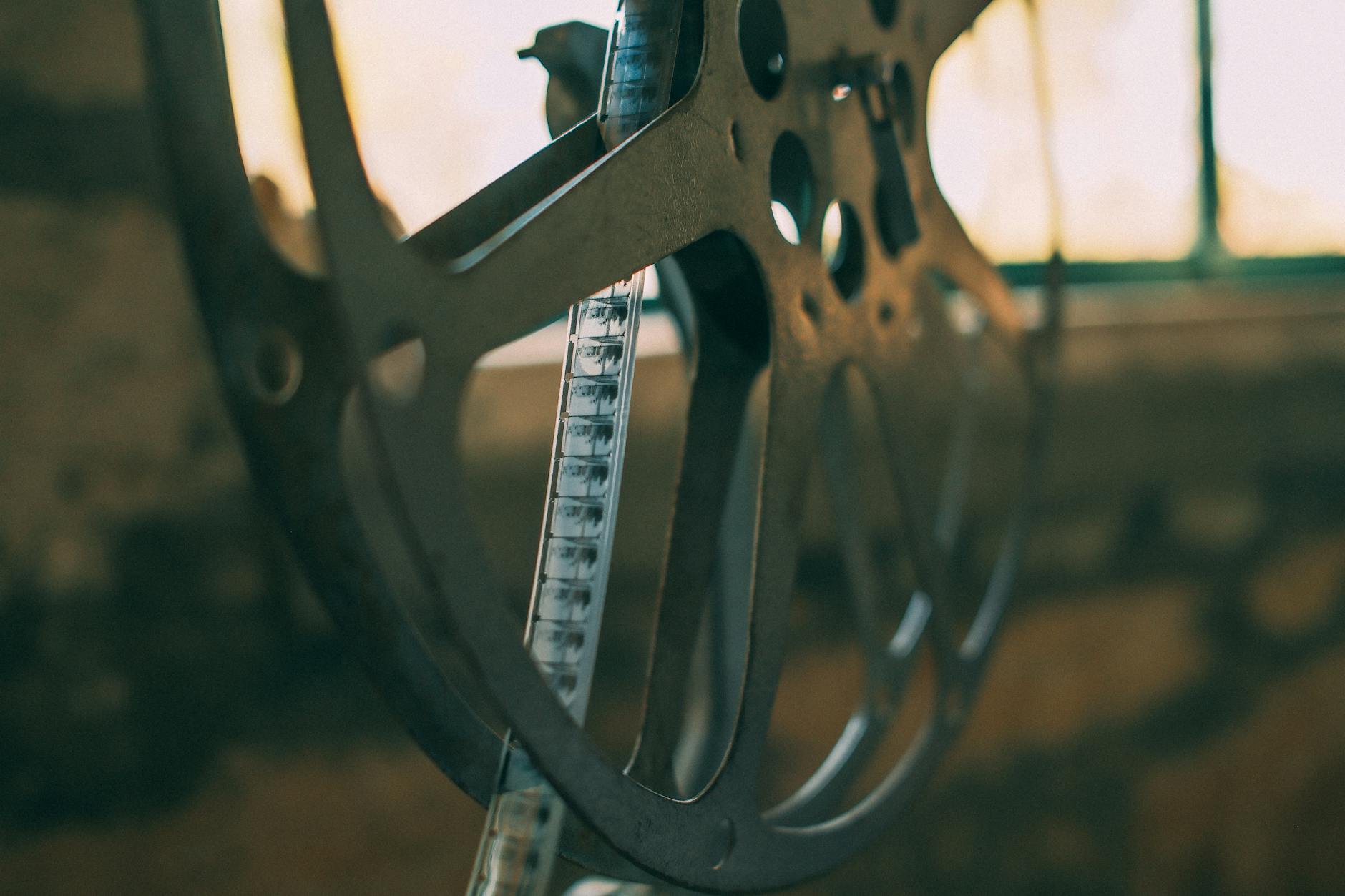 Artistic shot of a vintage film reel with soft light creating a nostalgic atmosphere.