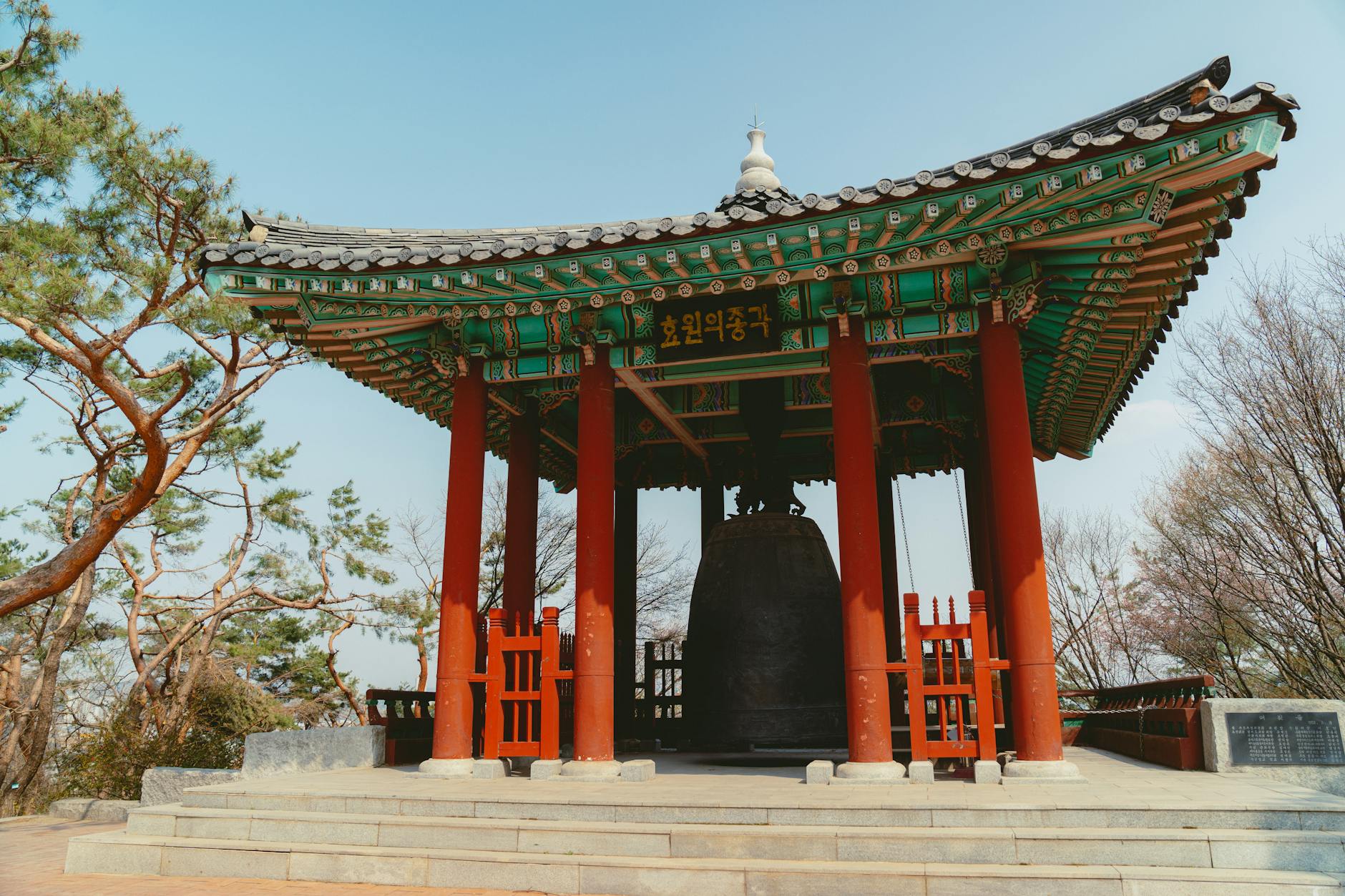 Stunning view of a traditional Korean pavilion in a serene Seoul park setting, showcasing vibrant architecture.